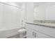 Bright bathroom featuring white cabinets, granite countertops, and a shower-tub combination at 1741 Forest Run Ln, Auburndale, FL 33823