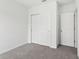 Bedroom featuring gray carpet, white walls, and closet offering a serene and functional space at 1741 Forest Run Ln, Auburndale, FL 33823