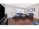 Living room with hardwood floors, featuring a comfortable seating area at 117 E Lauren Ct, Fern Park, FL 32730