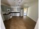 Bright kitchen features neutral cabinets, laminate countertops, white appliances, and wood-look flooring at 821 Savona Pl, Kissimmee, FL 34758