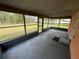 View of a screened in porch overlooking the backyard with grass and trees at 821 Savona Pl, Kissimmee, FL 34758