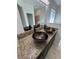 Bathroom featuring double vessel sinks and a granite countertop at 1780 Converse Ct, Deltona, FL 32738