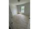 Empty bedroom featuring tile flooring and natural light from the window at 1780 Converse Ct, Deltona, FL 32738