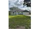 Inviting single-story home featuring a two-car garage, well-maintained lawn, and classic architectural design at 1780 Converse Ct, Deltona, FL 32738