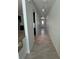 Long hallway with tile floors leads to the front door and showcases the open floor plan at 1780 Converse Ct, Deltona, FL 32738