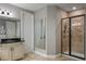 Modern bathroom featuring tiled shower, vanity with a black countertop, and a decorative mirror for a stylish touch at 8300 Ludington Cir, Orlando, FL 32836