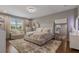 Elegant bedroom featuring a plush rug, accent chair, and a luxurious bed with decorative pillows at 8300 Ludington Cir, Orlando, FL 32836
