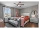 Cozy bedroom with a comfortable bed, sofa, and lots of natural light from a large window at 8300 Ludington Cir, Orlando, FL 32836