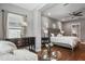 Spacious bedroom showcasing a cozy sitting area, hardwood floors, and elegant decor for a relaxing atmosphere at 8300 Ludington Cir, Orlando, FL 32836
