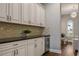 A well-appointed butlers pantry with sleek countertops, custom cabinetry, and a wine refrigerator for entertaining at 8300 Ludington Cir, Orlando, FL 32836
