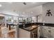 Open-concept kitchen and living area with dark countertops, a pool table, and lots of natural light at 8300 Ludington Cir, Orlando, FL 32836