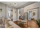 Open-concept living area featuring a modern chandelier, wood floors, and neutral decor for a bright and airy feel at 8300 Ludington Cir, Orlando, FL 32836