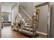 A modern staircase with metal railings and dark wood steps stands next to a large decorative mirror at 8300 Ludington Cir, Orlando, FL 32836