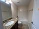 Bathroom includes a bathtub, granite vanity, and tiled flooring at 9002 Majesty Palm Rd, Kissimmee, FL 34747