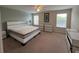 Spacious main bedroom with a king bed, large windows and neutral decor at 9002 Majesty Palm Rd, Kissimmee, FL 34747