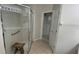 Bright bathroom featuring a glass door shower with a wooden stool and an open doorway at 681 Coronado Dr, Kissimmee, FL 34759