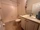 Bathroom with a single sink vanity, tiled floor, and bathtub with shower at 681 Coronado Dr, Kissimmee, FL 34759