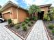 Well-maintained front garden and walkway leading to the entrance of this lovely home at 681 Coronado Dr, Kissimmee, FL 34759