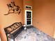 Inviting front porch area with stylish outdoor seating, decor, and tiled flooring at 681 Coronado Dr, Kissimmee, FL 34759