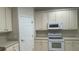 Neutral kitchen features a built-in microwave and range at 681 Coronado Dr, Kissimmee, FL 34759