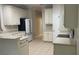 Neutral kitchen features a breakfast bar and tile flooring at 681 Coronado Dr, Kissimmee, FL 34759