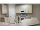 Kitchen with cream colored cabinetry, laminate counters and stainless-steel appliances at 681 Coronado Dr, Kissimmee, FL 34759