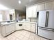 Clean kitchen featuring white cabinets, stainless steel appliances, and neutral countertops at 681 Coronado Dr, Kissimmee, FL 34759