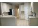 Neutral kitchen features a breakfast bar and tile flooring at 681 Coronado Dr, Kissimmee, FL 34759