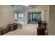 Living room featuring plush carpet with sliding glass door access to a screened-in patio at 681 Coronado Dr, Kissimmee, FL 34759