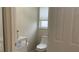 Toilet area featuring a window and toilet paper holder at 681 Coronado Dr, Kissimmee, FL 34759
