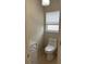 Toilet area featuring a window and toilet paper holder at 681 Coronado Dr, Kissimmee, FL 34759