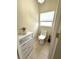 Cozy toilet room featuring a tiled floor, toilet, and storage cabinet at 681 Coronado Dr, Kissimmee, FL 34759
