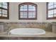 Relaxing bathroom with a large soaking tub and window at 729 San Raphael St, Kissimmee, FL 34759