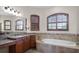 Spa-like bathroom featuring a soaking tub and double vanity at 729 San Raphael St, Kissimmee, FL 34759