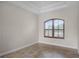 Spacious bedroom with tile floors and an arched window with shutters at 729 San Raphael St, Kissimmee, FL 34759
