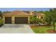 Two-story house with a tile roof, two-car garage, and landscaped yard at 729 San Raphael St, Kissimmee, FL 34759