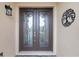 Double front doors with glass inserts and decorative metalwork at 729 San Raphael St, Kissimmee, FL 34759