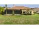 House back view with covered patio and well-maintained lawn at 729 San Raphael St, Kissimmee, FL 34759