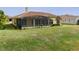 House back view with covered patio and well-maintained lawn at 729 San Raphael St, Kissimmee, FL 34759