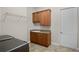 Well-equipped laundry room with washer, dryer, cabinets, and sink at 729 San Raphael St, Kissimmee, FL 34759