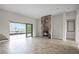 Living room features tile floors, a stone fireplace, and sliding glass doors at 729 San Raphael St, Kissimmee, FL 34759
