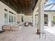 Inviting outdoor living area featuring travertine flooring, wood ceiling, and comfortable seating, perfect for relaxing at 9905 Lanai View Ct, Windermere, FL 34786