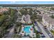 Aerial view of a community with a pool, lake, and lush landscaping at 3432 Westchester Square Blvd # 205, Orlando, FL 32835