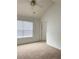 Neutral bedroom with window and plush carpeting, showcasing natural light at 3432 Westchester Square Blvd # 205, Orlando, FL 32835