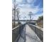 A wooden boardwalk stretches over the lake, leading to a covered gazebo and offering scenic water views at 3432 Westchester Square Blvd # 205, Orlando, FL 32835