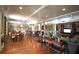 Spacious clubhouse featuring tables, chairs, bar seating, a television, and a couch at 3432 Westchester Square Blvd # 205, Orlando, FL 32835