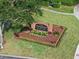 Well-maintained community sign with landscaping features and mature tree providing shade and curb appeal at 3432 Westchester Square Blvd # 205, Orlando, FL 32835