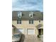Well-maintained townhome with brick driveway, attached garages, and dormer windows providing natural light at 3432 Westchester Square Blvd # 205, Orlando, FL 32835