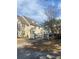 Charming townhome exterior featuring well-maintained landscaping, decorative fences, and inviting entrances at 3432 Westchester Square Blvd # 205, Orlando, FL 32835