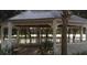 Community gazebo with white posts and railings overlooks the lake with palm trees and clear skies in the background at 3432 Westchester Square Blvd # 205, Orlando, FL 32835
